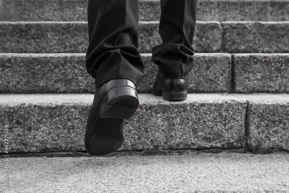 Businessman walking up the stairs outdoors
