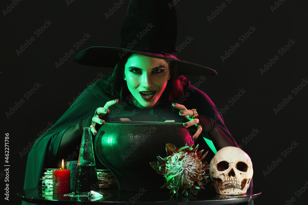 Witch performing ritual on black background