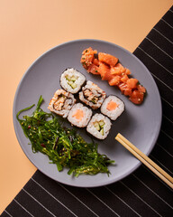 Poster - Set of traditional asian sushi rolls and wooden chopsticks