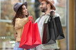 © Pixel-Shot - Couple with shopping bags on city street