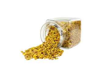 Bee pollen pouring out of the glass jar isolated on white background. natural herbal medicine