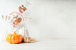 © Anna - Details of Still life, pumpkins, candle, brunch with leaves on white table background, home decor in a cozy house. Autumn weekend concept. Fallen leaves and home decoration