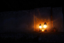 Night Cemetery Background Tombstone With Memorial Lamps Flame Warm Light, Soft Focus Concept With Empty Copy Space For Thematic Text