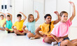© JackF - Group of emotional children doing yoga in a dance studio