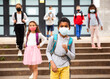 © JackF - African american tween schoolboy in protective mask with backpacks going to school lessons on fall day. Back school concept during pandemic
