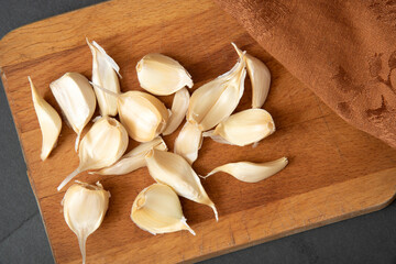 Poster - Garlic cloves on a cutting board overhead view