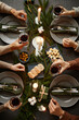 © Seventyfour - Top view background of four people enjoying Christmas dinner together while sitting by elegant dining table with candles lit, copy space