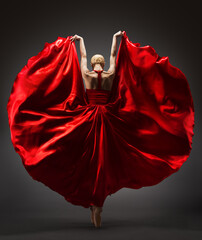 Wall Mural - Ballerina Dancing in Red Flying Dress Rear Back Side View. Graceful Woman Ballet Performer in Flamenco Skirt. Expressive Passion Dance in Motion over Dark Background