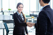 © Thinapob - businesswoman and businessman shaking hands at In the office room background after the contract is signed or handshake greeting deal,business expressed confidence embolden and successful concept
