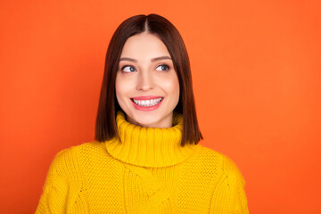 Wall Mural - Photo of young excited woman happy positive smile look empty space curious interested isolated over orange color background