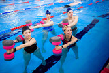 Avka aerobics in the swimming pool. A group of young people in training.