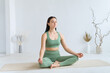 © Вадим Каштанов - Young woman practices yoga in the lotus position. Cross-legged pose.