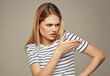 © SHOTPRIME STUDIO - disgruntled woman in striped t-shirt gesturing with her hands