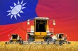 four orange combine harvesters on grain field with flag background, Taiwan Province of China agriculture concept - industrial 3D illustration