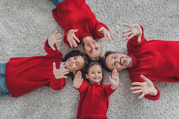 Poster - Top above high angle view of beautiful handsome cheerful family lying on carpet having fun December spirit at home indoors