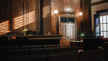Empty American Style Courtroom. Supreme Court Of Law And Justice Trial Stand. Courthouse Before Civil Case Hearing Starts. Grand Wooden Interior With Judge's Bench, Defendant's And Plaintiff's Tables.