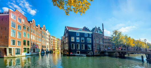 Wall Mural - Amsterdam. Panoramic view of the historic city center of Amsterdam. Traditional houses  of Amsterdam. Beautiful autumn sunny day. A European travel to a historic town. 