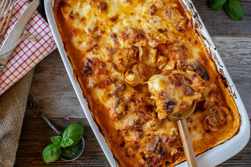 Wall Mural - Vegetarian pasta casserole with tortellini, tomato sauce and cheese topping