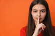© Drobot Dean - Young white brunette woman showing silence gesture at camera