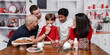 © Tamara Sales  - family, kids, baking Christmas cookies having family time traditions Stock photo Royalty free
