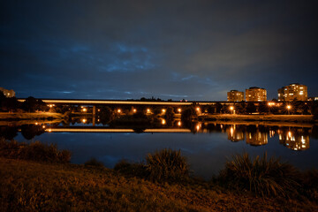 Poster - Modern metro tube over park pond in Prague at night