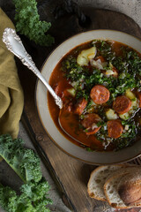 Wall Mural - bowl of soup with kale, potatoes and chorizo sausages on the table