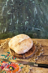 Wall Mural - Homemade sourdough bread. Wooden background, side view.