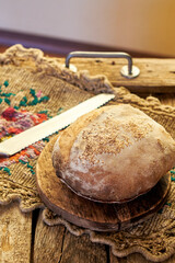 Wall Mural - Homemade sourdough bread. Wooden background, side view.