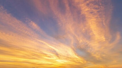 Wall Mural - 4k time lapse of twilight blue bright and orange yellow dramatic sunrise or sunset sky and clouds mo