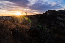 Silhouette Of Two Trail Runners In Badlands