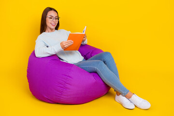 Sticker - Full length photo of happy nice young lady enjoy sit chair hold book read isolated on yellow color background