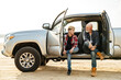 © Drobot Dean - Smiling father and his son sitting in a car trunk