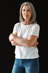 Wall Mural - Grey senior woman in t-shirt posing and looking at camera