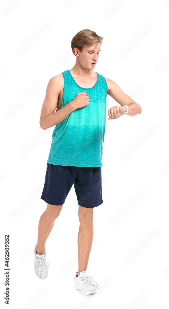 Sporty male runner checking pulse on white background