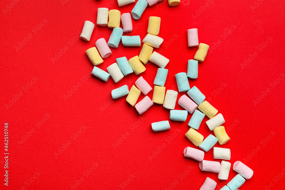 Tasty colorful marshmallows on color background