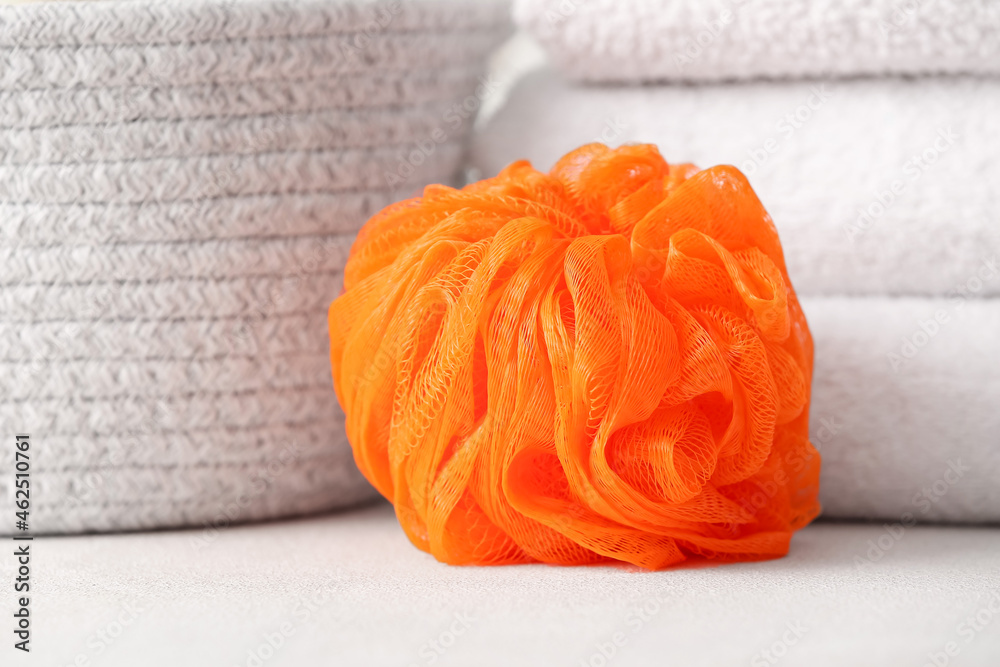 Soft orange sponge on table, closeup