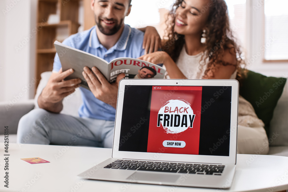 Couple shopping online on Black Friday at home