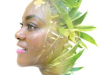 Wall Mural - A double exposure portrait of a female model combined with an image of green leaves.