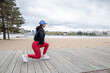 Young sportswoman training lunges outdoors
