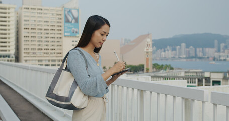 Poster - Woman sketch on tablet computer of cityscape in Hong Kong