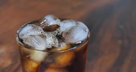 Wall Mural - cold black coffee in a cup,Cup of coffee close-up.