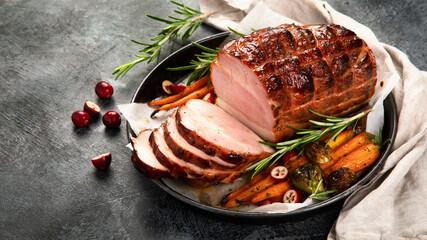 Wall Mural - Baked ham with vegetables on dark background.