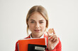 © SHOTPRIME STUDIO - Businesswoman in a red jacket with documents in hand isolated background