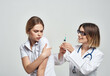 © SHOTPRIME STUDIO - nurse syringe in hand treatment isolated background