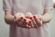 © RooM The Agency - Close-up of a woman holding a handful of fresh apricots