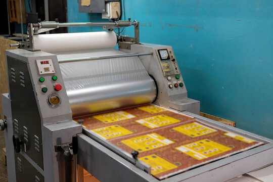 Industrial laminator, lamination of paper products. The manufacture of packaging. Outdated equipment. Company. Place for text.