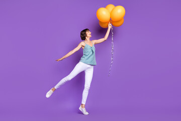 Wall Mural - Full length body size view of attractive cheerful girl holding balls dancing event isolated over bright purple violet color background