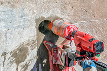 Worker Is Drilling To Concrete Wall With Core Drill Machine. Core Drills Used In Metal Are Called Annular Cutters. Core Drills Used For Concrete And Hard Rock Generally Use Industrial Diamond Grit.