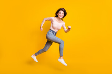 Sticker - Full size profile side photo of young happy positive lovely woman running in air isolated on yellow color background