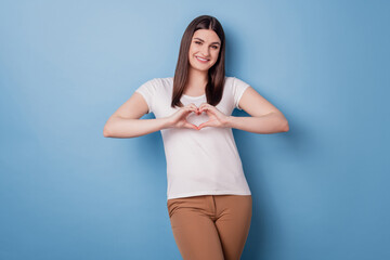 Wall Mural - Portrait of adorable girlfriend cute lady show heart gesture toothy smile on blue background